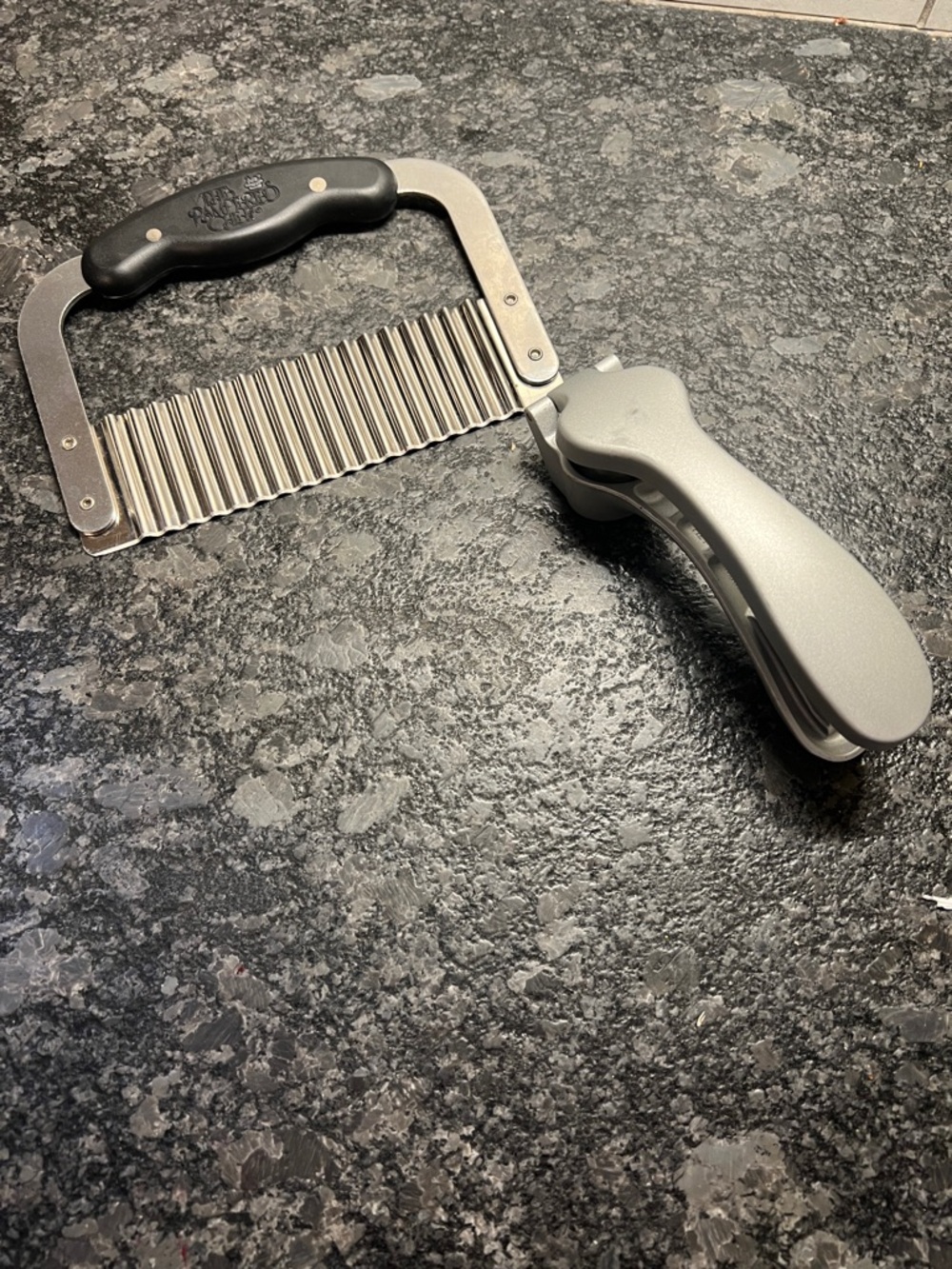Set of 2 items Pampered Chef Stainless Steel Crinkle Cutter  and a garlic press.